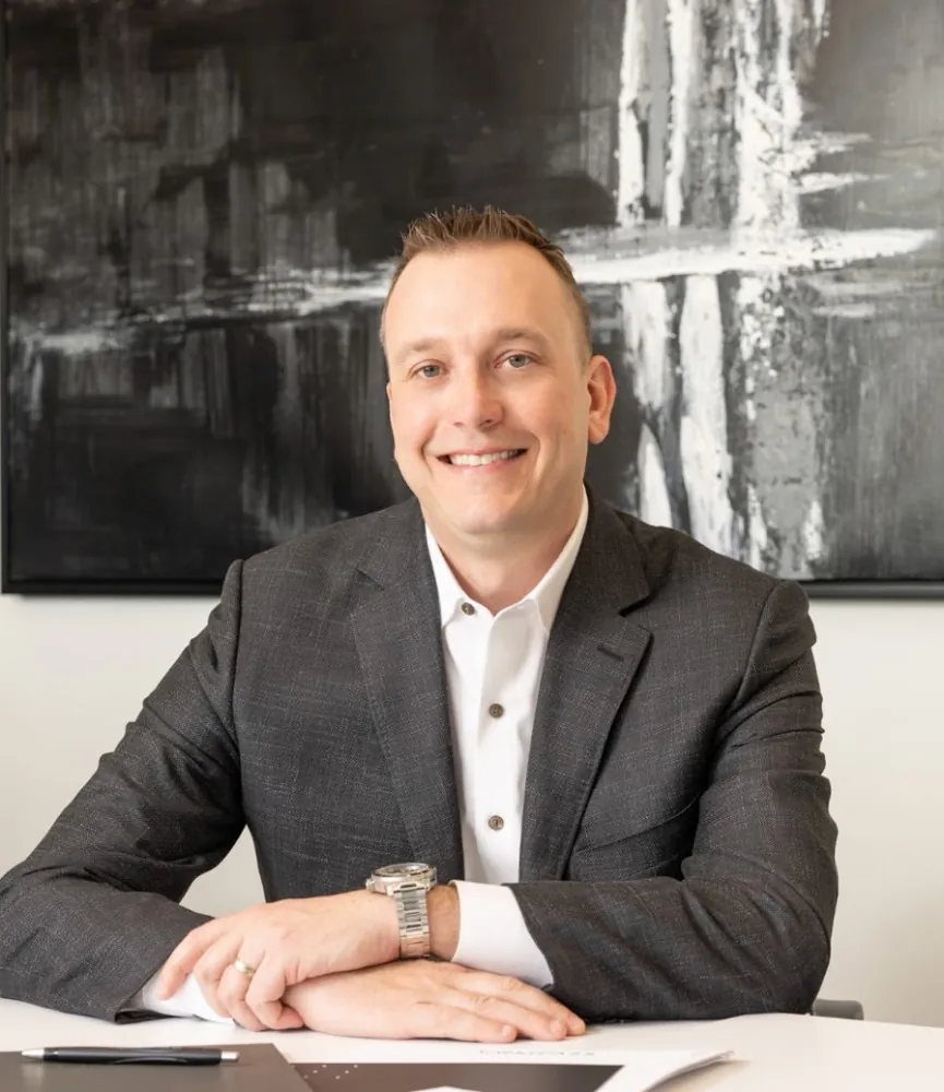 Professional portrait of Brent Voeppel at a desk